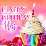 A vibrant birthday GIF featuring a rainbow-colored cupcake topped with white frosting, sprinkles, and a lit candle. The text reads 'Happy Birthday Hai' in bold pink and violet letters with white outline.