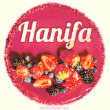 Beautifully decorated red velvet berry birthday cake with vibrant fruits and a glowing 'Hanifa' name, adding a touch of sweetness and sparkle.