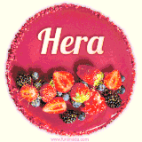 Beautifully decorated red velvet berry birthday cake with vibrant fruits and a glowing 'Hera' name, adding a touch of sweetness and sparkle.