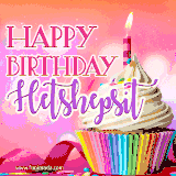 A vibrant birthday GIF featuring a rainbow-colored cupcake topped with white frosting, sprinkles, and a lit candle. The text reads 'Happy Birthday Hetshepsit' in bold pink and violet letters with white outline.