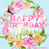 A charming animated GIF featuring 'Happy Birthday Hikari' in pink and green text, surrounded by delicate roses, leaves, and fluttering butterflies on a soft light blue pastel background.