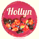 Beautifully decorated red velvet berry birthday cake with vibrant fruits and a glowing 'Hollyn' name, adding a touch of sweetness and sparkle.