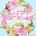 A charming animated GIF featuring 'Happy Birthday Indy' in pink and green text, surrounded by delicate roses, leaves, and fluttering butterflies on a soft light blue pastel background.