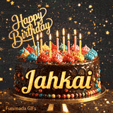 Flickering candles of different colors on top of a chocolate glaze cake with Jahkai's name in elegant writing.