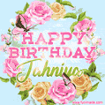 A charming animated GIF featuring 'Happy Birthday Jahniya' in pink and green text, surrounded by delicate roses, leaves, and fluttering butterflies on a soft light blue pastel background.