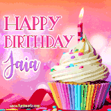 A vibrant birthday GIF featuring a rainbow-colored cupcake topped with white frosting, sprinkles, and a lit candle. The text reads 'Happy Birthday Jaia' in bold pink and violet letters with white outline.