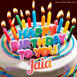 A colorful birthday cake topped with lit candles, with the words 'Happy Birthday Jaia' in bold glowing letters on a burgundy background. Animated flames add a festive touch.