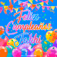 A vibrant animated GIF with 'Feliz Cumpleaños Jakhi' written in colorful script, surrounded by balloons, confetti, and bunting on a bright blue background.
