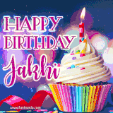 A festive animated GIF featuring a colorful cupcake with a single lit candle, sprinkles, and 'Happy Birthday Jakhi' text against a sparkling, celebratory background.