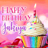 A vibrant birthday GIF featuring a rainbow-colored cupcake topped with white frosting, sprinkles, and a lit candle. The text reads 'Happy Birthday Jakiya' in bold pink and violet letters with white outline.