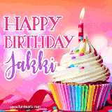 A vibrant birthday GIF featuring a rainbow-colored cupcake topped with white frosting, sprinkles, and a lit candle. The text reads 'Happy Birthday Jakki' in bold pink and violet letters with white outline.