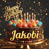 Bright candles flickering on a festive chocolate cake with the name Jakobi displayed in golden letters.