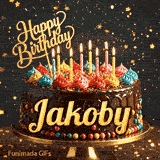 Golden lettering spelling Jakoby on a rich chocolate birthday cake decorated with rainbow sprinkles.