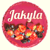 Beautifully decorated red velvet berry birthday cake with vibrant fruits and a glowing 'Jakyla' name, adding a touch of sweetness and sparkle.