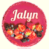 Beautifully decorated red velvet berry birthday cake with vibrant fruits and a glowing 'Jalyn' name, adding a touch of sweetness and sparkle.