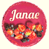 Beautifully decorated red velvet berry birthday cake with vibrant fruits and a glowing 'Janae' name, adding a touch of sweetness and sparkle.