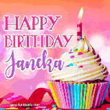 A vibrant birthday GIF featuring a rainbow-colored cupcake topped with white frosting, sprinkles, and a lit candle. The text reads 'Happy Birthday Janeka' in bold pink and violet letters with white outline.
