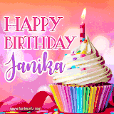 A vibrant birthday GIF featuring a rainbow-colored cupcake topped with white frosting, sprinkles, and a lit candle. The text reads 'Happy Birthday Janika' in bold pink and violet letters with white outline.