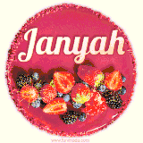 Beautifully decorated red velvet berry birthday cake with vibrant fruits and a glowing 'Janyah' name, adding a touch of sweetness and sparkle.