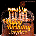 A rich chocolate cake topped with glowing birthday candles and surrounded by bright fireworks. The animated GIF displays the message 'Happy Birthday Jaydon' in golden text.