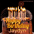 A rich chocolate cake topped with glowing birthday candles and surrounded by bright fireworks. The animated GIF displays the message 'Happy Birthday Jaydyn' in golden text.