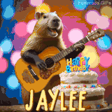 Animated birthday GIF showing a capybara playing guitar and singing beside a birthday cake with the name Jaylee in large letters and colorful bokeh lights in the background.