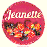 Beautifully decorated red velvet berry birthday cake with vibrant fruits and a glowing 'Jeanette' name, adding a touch of sweetness and sparkle.
