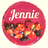 Beautifully decorated red velvet berry birthday cake with vibrant fruits and a glowing 'Jennie' name, adding a touch of sweetness and sparkle.