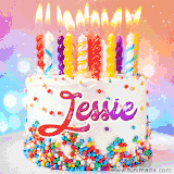 A cheerful white birthday cake with multicolor sprinkles, lit candles, and 'Jessie' written in vibrant letters, in an animated GIF.