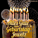 A chocolate birthday cake with glowing candles, the German text 'Alles Gute zum Geburtstag Jewelz,' and vibrant fireworks lighting up the background in an animated GIF.