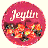 Beautifully decorated red velvet berry birthday cake with vibrant fruits and a glowing 'Jeylin' name, adding a touch of sweetness and sparkle.