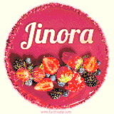 Beautifully decorated red velvet berry birthday cake with vibrant fruits and a glowing 'Jinora' name, adding a touch of sweetness and sparkle.