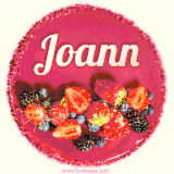Beautifully decorated red velvet berry birthday cake with vibrant fruits and a glowing 'Joann' name, adding a touch of sweetness and sparkle.