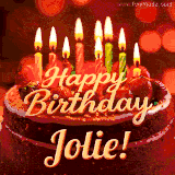 Beautifully decorated red velvet berry birthday cake with vibrant fruits and a glowing 'Jolie' name, adding a touch of sweetness and sparkle.
