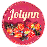 Beautifully decorated red velvet berry birthday cake with vibrant fruits and a glowing 'Jolynn' name, adding a touch of sweetness and sparkle.