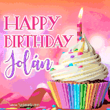 A vibrant birthday GIF featuring a rainbow-colored cupcake topped with white frosting, sprinkles, and a lit candle. The text reads 'Happy Birthday Jolán' in bold pink and violet letters with white outline.