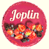 Beautifully decorated red velvet berry birthday cake with vibrant fruits and a glowing 'Joplin' name, adding a touch of sweetness and sparkle.