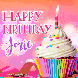 A vibrant birthday GIF featuring a rainbow-colored cupcake topped with white frosting, sprinkles, and a lit candle. The text reads 'Happy Birthday Jorie' in bold pink and violet letters with white outline.