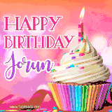 A vibrant birthday GIF featuring a rainbow-colored cupcake topped with white frosting, sprinkles, and a lit candle. The text reads 'Happy Birthday Jorun' in bold pink and violet letters with white outline.