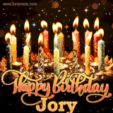 A glowing personalized birthday GIF with name Jory featuring lit candles with intricate designs, warm lighting, and the text 'Happy Birthday' in an elegant font.