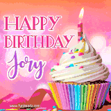 A vibrant birthday GIF featuring a rainbow-colored cupcake topped with white frosting, sprinkles, and a lit candle. The text reads 'Happy Birthday Jory' in bold pink and violet letters with white outline.