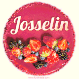 Beautifully decorated red velvet berry birthday cake with vibrant fruits and a glowing 'Josselin' name, adding a touch of sweetness and sparkle.