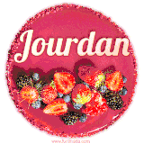 Beautifully decorated red velvet berry birthday cake with vibrant fruits and a glowing 'Jourdan' name, adding a touch of sweetness and sparkle.