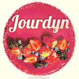Beautifully decorated red velvet berry birthday cake with vibrant fruits and a glowing 'Jourdyn' name, adding a touch of sweetness and sparkle.