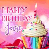 A vibrant birthday GIF featuring a rainbow-colored cupcake topped with white frosting, sprinkles, and a lit candle. The text reads 'Happy Birthday Jovie' in bold pink and violet letters with white outline.