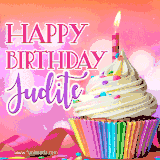 A vibrant birthday GIF featuring a rainbow-colored cupcake topped with white frosting, sprinkles, and a lit candle. The text reads 'Happy Birthday Judite' in bold pink and violet letters with white outline.