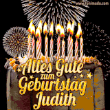 A chocolate birthday cake with glowing candles, the German text 'Alles Gute zum Geburtstag Judith,' and vibrant fireworks lighting up the background in an animated GIF.