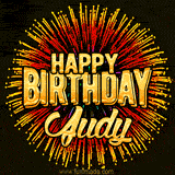 Golden 'Happy Birthday Judy' text accompanied by animated rainbow fireworks for a festive animated greeting.