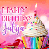 A vibrant birthday GIF featuring a rainbow-colored cupcake topped with white frosting, sprinkles, and a lit candle. The text reads 'Happy Birthday Julija' in bold pink and violet letters with white outline.