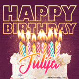 A colorful birthday cake topped with lit candles, with the words 'Happy Birthday Julija' in bold glowing letters on a burgundy background. Animated flames add a festive touch.
